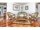 Cozy seating area with wicker furniture, hardwood floors, and neutral colored walls at 12303 Fieldstone Ln, Hudson, FL 34667