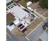 Aerial view of a one story pink house with grey roof, fenced in backyard and multiple cars parked in driveway at 12425 Ridge Rd, Largo, FL 33778