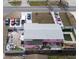 Aerial view of pink house with backyard, patio and pool, surrounded by a fence with multiple cars in driveway at 12425 Ridge Rd, Largo, FL 33778
