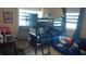 Shared bedroom featuring a bunk bed, desk and blue sofa at 12425 Ridge Rd, Largo, FL 33778