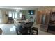 Open living area with white floors, cream colored couch, stainless steel appliances and dining area seating four at 12425 Ridge Rd, Largo, FL 33778