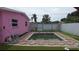 A private pool surrounded by artificial turf in a fenced backyard at 12425 Ridge Rd, Largo, FL 33778