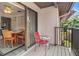 Relaxing balcony area with a red chair and adjacent dining area, perfect for outdoor enjoyment at 12804 Wedgewood Way # C, Hudson, FL 34667