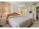 Cozy bedroom with a comfortable bed, striped wallpaper, and soft, natural light at 12804 Wedgewood Way # C, Hudson, FL 34667
