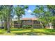 Two-story condo building with a lawn and mature trees at 12804 Wedgewood Way # C, Hudson, FL 34667