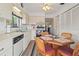 Charming kitchen and dining area with white appliances, cabinetry, and a bright window at 12804 Wedgewood Way # C, Hudson, FL 34667