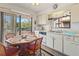 Cozy eat-in kitchen featuring white cabinets and natural light at 12804 Wedgewood Way # C, Hudson, FL 34667