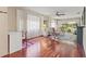 Bright living room with rich hardwood floors, large windows, and access to the lanai at 12804 Wedgewood Way # C, Hudson, FL 34667