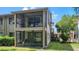 Enclosed two-story porch with chairs and a ceiling fan at 12804 Wedgewood Way # C, Hudson, FL 34667