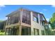 A view of the two-story enclosed porch from an angle at 12804 Wedgewood Way # C, Hudson, FL 34667