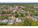 Aerial view of a lush, residential neighborhood with tree-lined streets and a community pool at 13211 111Th Ln, Largo, FL 33778