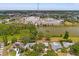 Aerial view showcasing property's proximity to local pond, foliage, and commercial buildings at 13211 111Th Ln, Largo, FL 33778