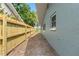Side yard shows new wooden fence and exterior of the house at 13211 111Th Ln, Largo, FL 33778