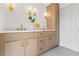 Bathroom featuring a double vanity with marble countertops, modern lighting, and linen closet at 13211 111Th Ln, Largo, FL 33778