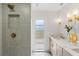 Luxurious bathroom with double vanity, marble countertop, gold fixtures, and designer lighting at 13211 111Th Ln, Largo, FL 33778