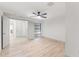 Spacious bedroom with light wood floors, a modern ceiling fan, and access to a private outdoor area at 13211 111Th Ln, Largo, FL 33778