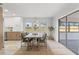 Elegant dining area featuring a wooden table with seating for four, and a sliding glass door to the backyard at 13211 111Th Ln, Largo, FL 33778