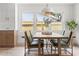 Bright dining room featuring a wooden table, stylish chairs, a modern light fixture, and light wood floors at 13211 111Th Ln, Largo, FL 33778