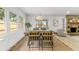Dining area with stone fireplace, stylish chairs, and a modern light fixture at 13211 111Th Ln, Largo, FL 33778