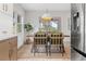 Bright dining room with stylish chairs, wooden table, and stainless steel refrigerator at 13211 111Th Ln, Largo, FL 33778