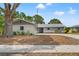 Charming single-story home with blue painted siding, white brick accents, and a well-manicured front lawn at 13211 111Th Ln, Largo, FL 33778
