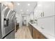 Well-lit kitchen with stainless steel appliances, granite countertops, and two-tone cabinetry at 13211 111Th Ln, Largo, FL 33778