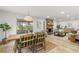 Open concept living and dining room with stone fireplace, wood floors, and outdoor views at 13211 111Th Ln, Largo, FL 33778