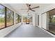Spacious sunroom with three ceiling fans and large windows offering backyard views at 13211 111Th Ln, Largo, FL 33778