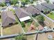 An aerial view showcasing the house with a spacious backyard and outdoor features at 14233 Edinburgh Moor Dr, Wimauma, FL 33598