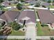 An aerial view showcases this charming single-Gathering home with a well-manicured lawn at 14233 Edinburgh Moor Dr, Wimauma, FL 33598