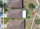 An aerial view of the property shows a well-maintained yard and outdoor features at 14233 Edinburgh Moor Dr, Wimauma, FL 33598