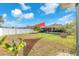 Backyard featuring lush green grass, a white fence, and shady areas at 14233 Edinburgh Moor Dr, Wimauma, FL 33598