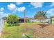 Landscaped backyard featuring lush green grass and privacy fence at 14233 Edinburgh Moor Dr, Wimauma, FL 33598
