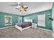 Primary bedroom featuring neutral carpet, light-filled windows, and a ceiling fan at 14233 Edinburgh Moor Dr, Wimauma, FL 33598