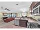 Open-concept kitchen featuring stainless steel appliances and a breakfast bar at 14233 Edinburgh Moor Dr, Wimauma, FL 33598