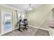Well-lit office space with French door access to a yard and neutral walls at 14233 Edinburgh Moor Dr, Wimauma, FL 33598