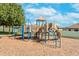 Community playground with colorful play structure on woodchips, perfect for outdoor fun at 14233 Edinburgh Moor Dr, Wimauma, FL 33598