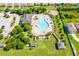 Aerial shot showcasing the community pool with lounge area, playground, landscaping, and ample parking at 14233 Edinburgh Moor Dr, Wimauma, FL 33598
