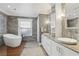 Luxurious bathroom features a freestanding tub, stone accent wall, and dual-sink vanity for a spa-like experience at 157 9Th N Ave, St Petersburg, FL 33701