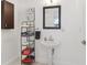 This bathroom features a pedestal sink, decorative mirror, and a storage rack for towels at 157 9Th N Ave, St Petersburg, FL 33701