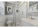 White bathroom features a glass shower, checkered tile floor, and modern fixtures, offering a fresh and clean design at 157 9Th N Ave, St Petersburg, FL 33701