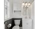 Clean bathroom with a toilet, sink and vanity, mirror, and white shower curtain at 157 9Th N Ave, St Petersburg, FL 33701