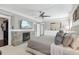 Bright bedroom features a stone fireplace, wall-mounted TV, and ample space, creating a cozy yet luxurious atmosphere at 157 9Th N Ave, St Petersburg, FL 33701