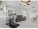 Bonus room with a stationary bike and sofa bathed in natural light from large windows at 157 9Th N Ave, St Petersburg, FL 33701