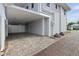 Attached carport with brick paver driveway leads to a privacy fence and landscaped yard at 157 9Th N Ave, St Petersburg, FL 33701