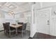 Elegant dining room featuring a rustic wooden table, stylish lighting, and views of the front entrance at 157 9Th N Ave, St Petersburg, FL 33701