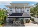 This two-story home features a large awning, an outdoor kitchen, and a second story balcony at 157 9Th N Ave, St Petersburg, FL 33701