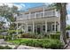 Charming home with a welcoming front porch, balcony, and lush landscaping at 157 9Th N Ave, St Petersburg, FL 33701
