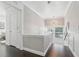 Bright hallway with hardwood floors, wainscoting, and stylish lighting, creating an inviting and elegant transition space at 157 9Th N Ave, St Petersburg, FL 33701
