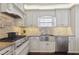 Well-equipped kitchen with stainless steel appliances, stylish tile backsplash, and ample counter space at 157 9Th N Ave, St Petersburg, FL 33701